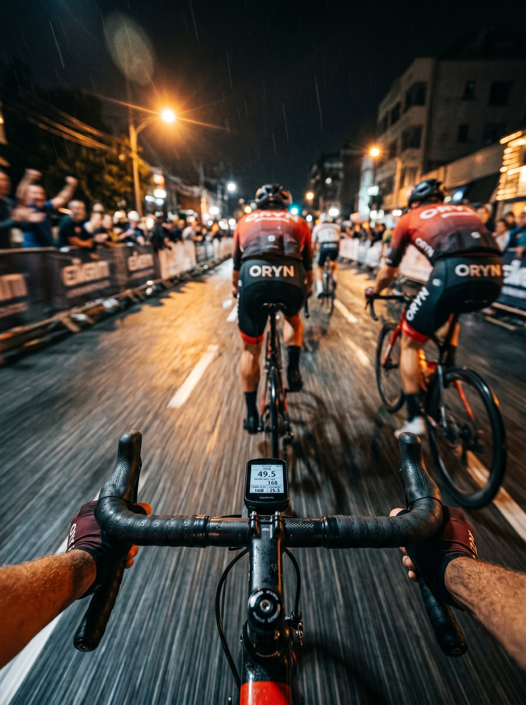 Cyclists racing on a city street at night with Oryx branding.