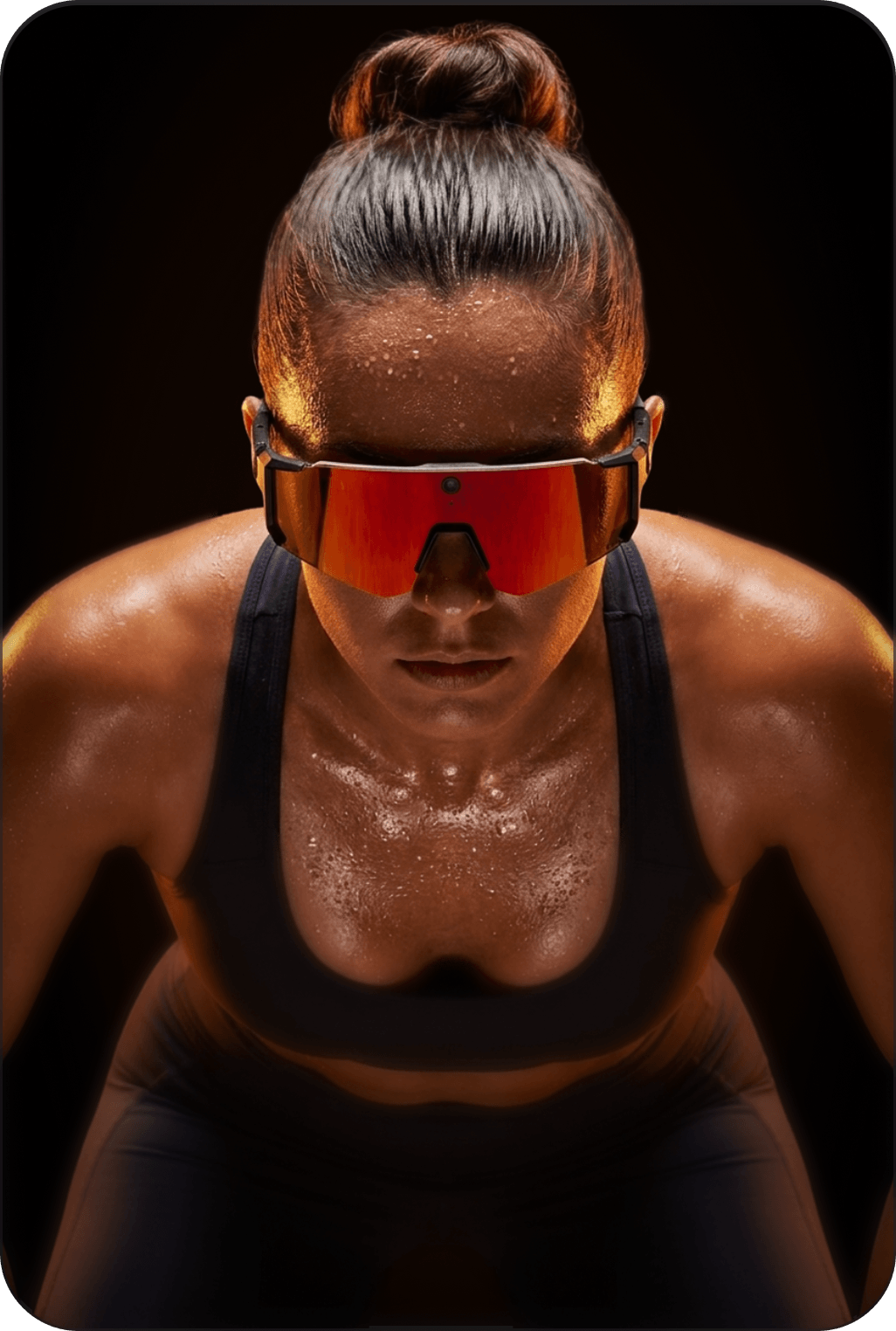 Person wearing reflective sunglasses with a dark background